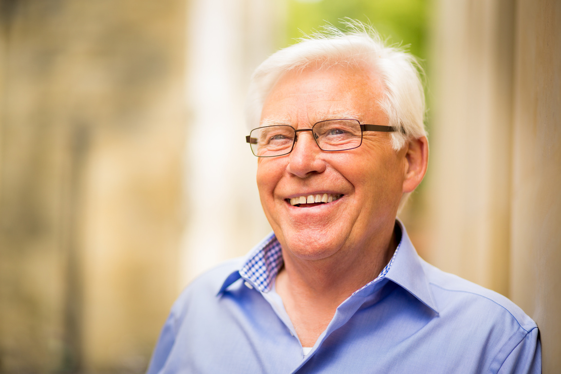 Older Man Smiling In Urban Area